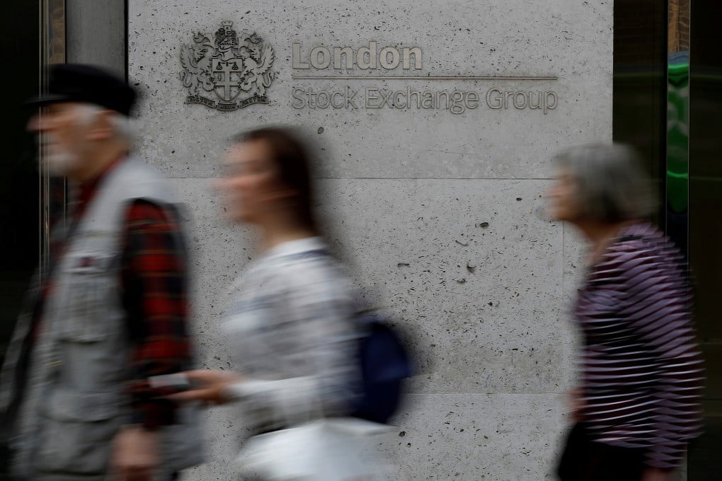 People walk past the entrance of the London Stock Exchange in London. Photo: Reuters