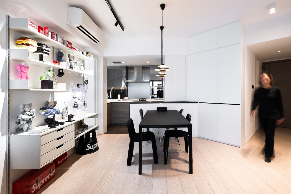 Eames, Fritz Hansen, Nils Holger Moormann and Moustache chairs surround the dining table of this high-rise Hong Kong apartment, where designer furniture and fittings - all authentic - stand out against a neutral backdrop. Photo: Eugene Chan