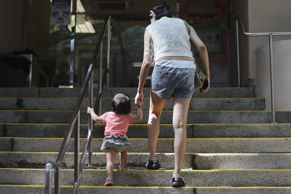 A woman with a toddler goes to Tsan Yuk Hospital in Sai Ying Pun. Hong Kong’s plummeting birth rate should be addressed holistically, with a refreshed population strategy. Photo: Xiaomei Chen
