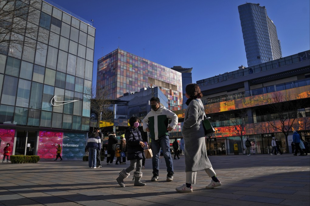 People walk through a shopping mall in Beijing in December 2022. Photo: AP