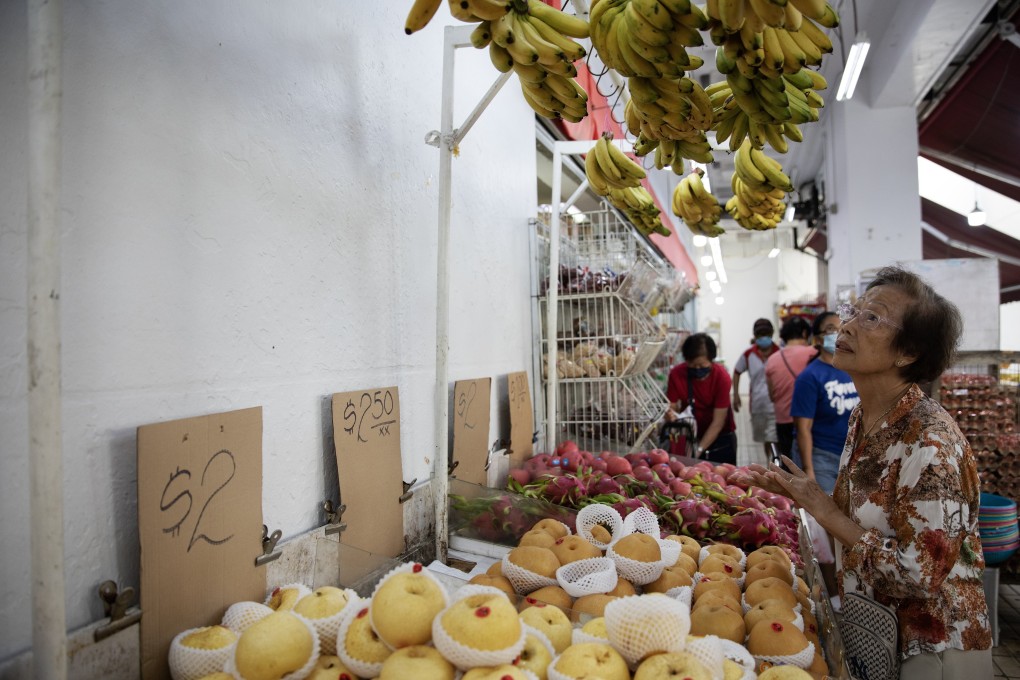 A woman looks at bananas on display at a market in Singapore on October 24. Asia’s economic fundamentals are much stronger than they were a decade ago, at least. Photo: EPA-EFE