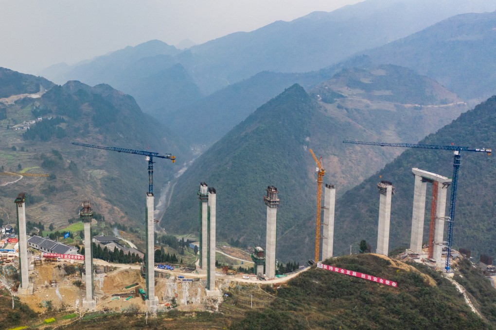An aerial view shows work being done on the Tuanjie Grand Bridge in China’s poverty-stricken Guizhou province. Photo: Xinhua