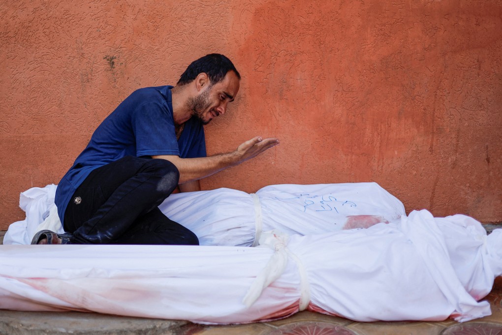 Palestinian man Mohammed al-Akhras next to the bodies of his daughter Jana and his wife who were killed by Israeli strikes in Gaza. Photo: Reuters