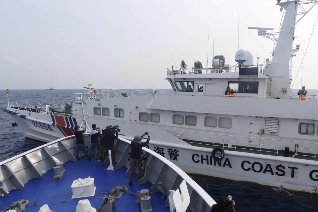 A Chinese coastguard ship sailing next to a Philippine coastguard patrol ship in the disputed South China Sea on October 4. Photo: EPA-EFE