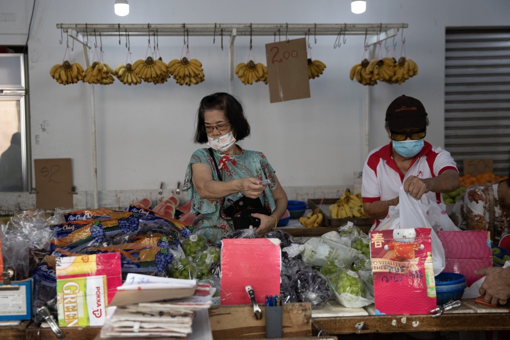 People buy fruit at a neighbourhood market in Singapore. The city state’s core inflation rate, which excludes private transport and accommodation costs, declined to 3 per cent in September from 3.4 percent in August, according to official data. Photo: EPA-EFE