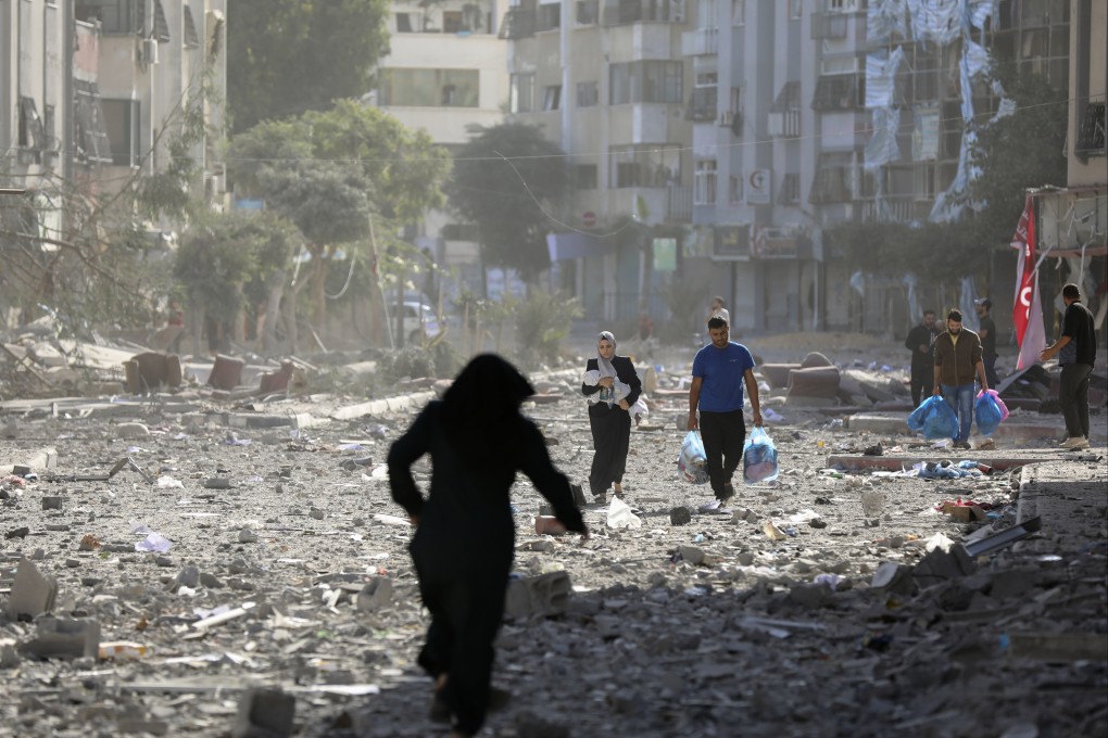 Palestinians leave their homes following Israeli bombardment of Gaza City on October 30. Photo: AP