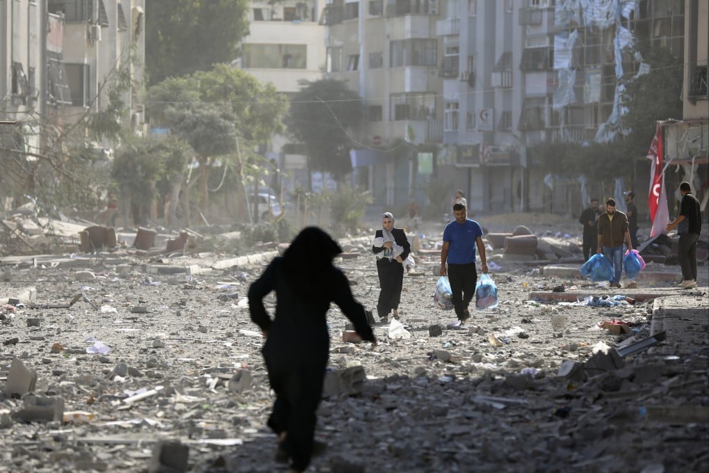 Palestinians leave their homes following Israeli bombardment of Gaza City on October 30. Photo: AP