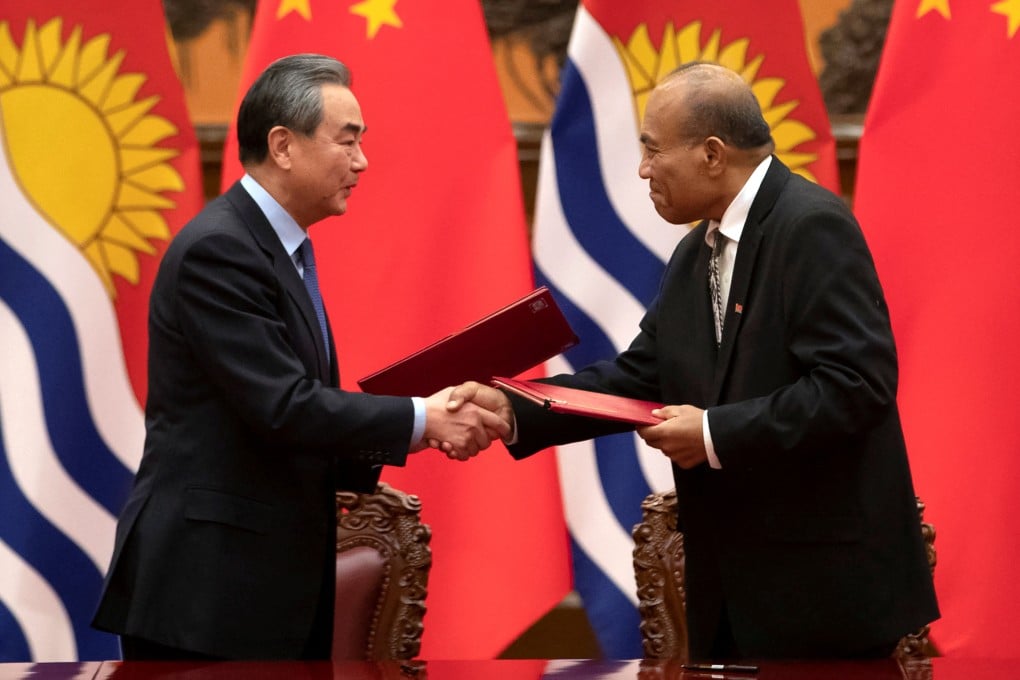 Chinese Foreign Minister Wang Yi and Kiribati’s President Taneti Maamau shake hands during a signing ceremony at the Great Hall of the People in Beijing in January 2020. Photo: Reuters