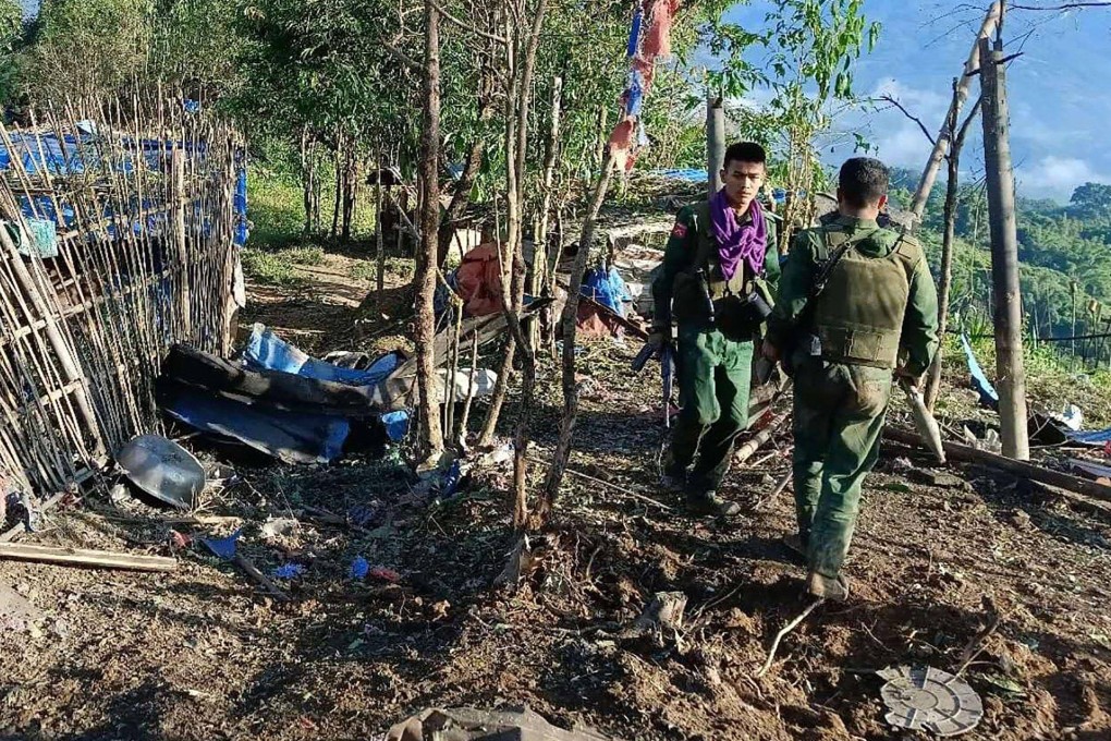 A photo from the Kokang Information Network on October 28 shows members of the MNDAA walking past a military base after seizing it during clashes near Laukkaing township in Myanmars northern Shan State. Photo: Kokang Information Network/AFP