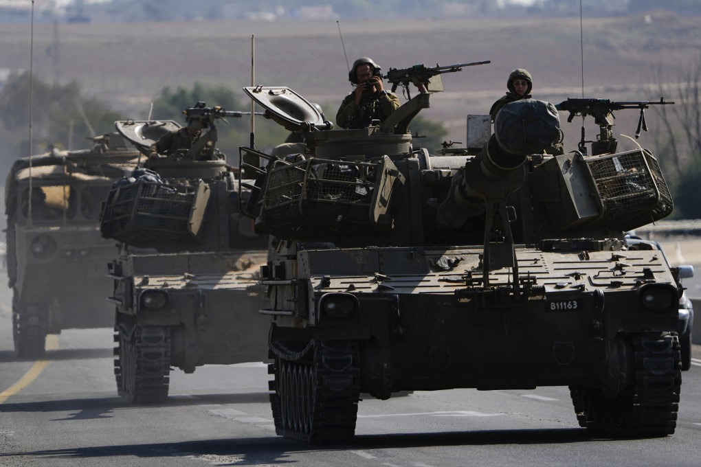 Israeli armoured personnel carriers and tanks move towards the Gaza Strip border in southern Israel. Photo: AP