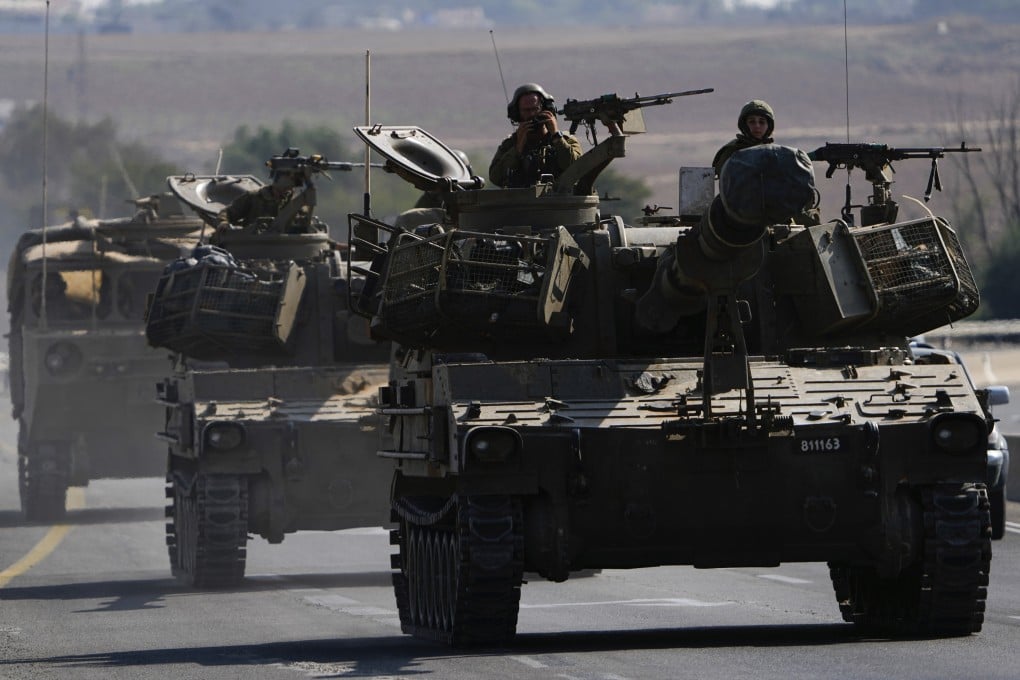 Israeli armoured personnel carriers and tanks move towards the Gaza Strip border in southern Israel. Photo: AP
