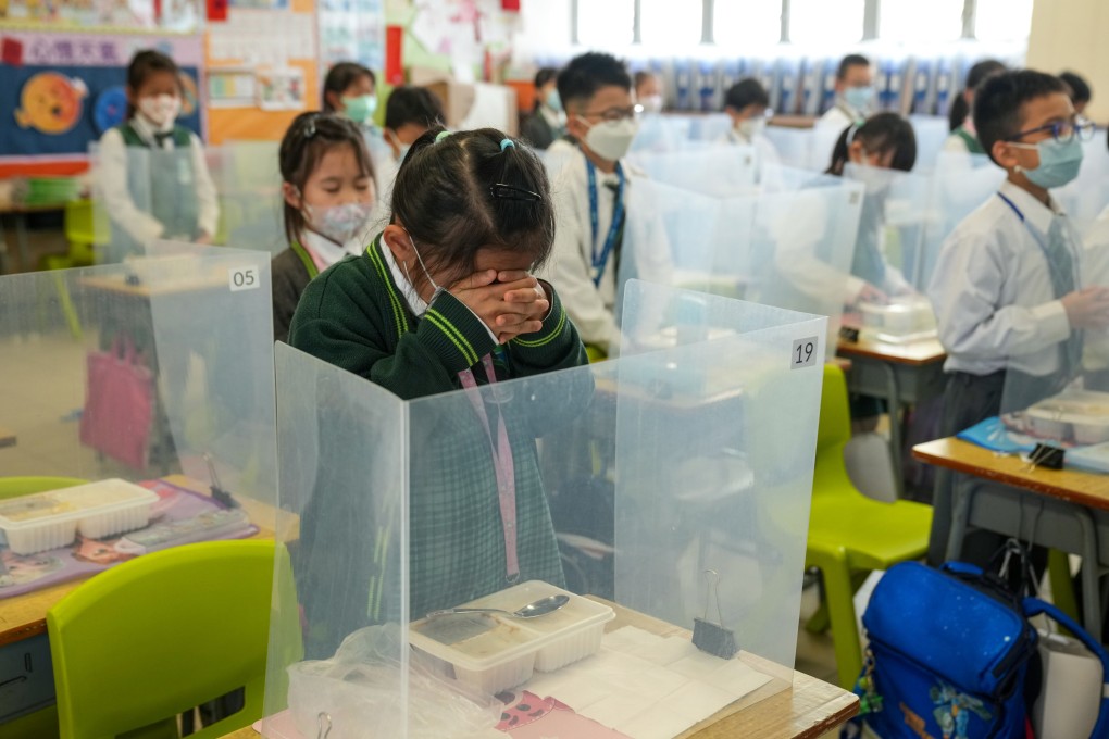 Children pray before their lunch at a school in Tin Shui Wai on February 20. Photo: Sam Tsang