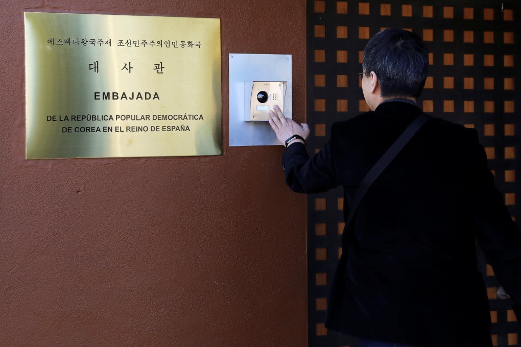 A journalist from South Korea rings an intercom of North Korea’s embassy in Madrid, Spain. Photo: Reuters/File