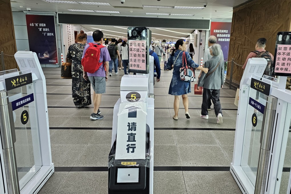 Travellers crossing the health declaration QR code scanner at Lo Wu border. Mainland authorities have lifted a mandatory Covid-19 health declaration. Photo: Edmond So