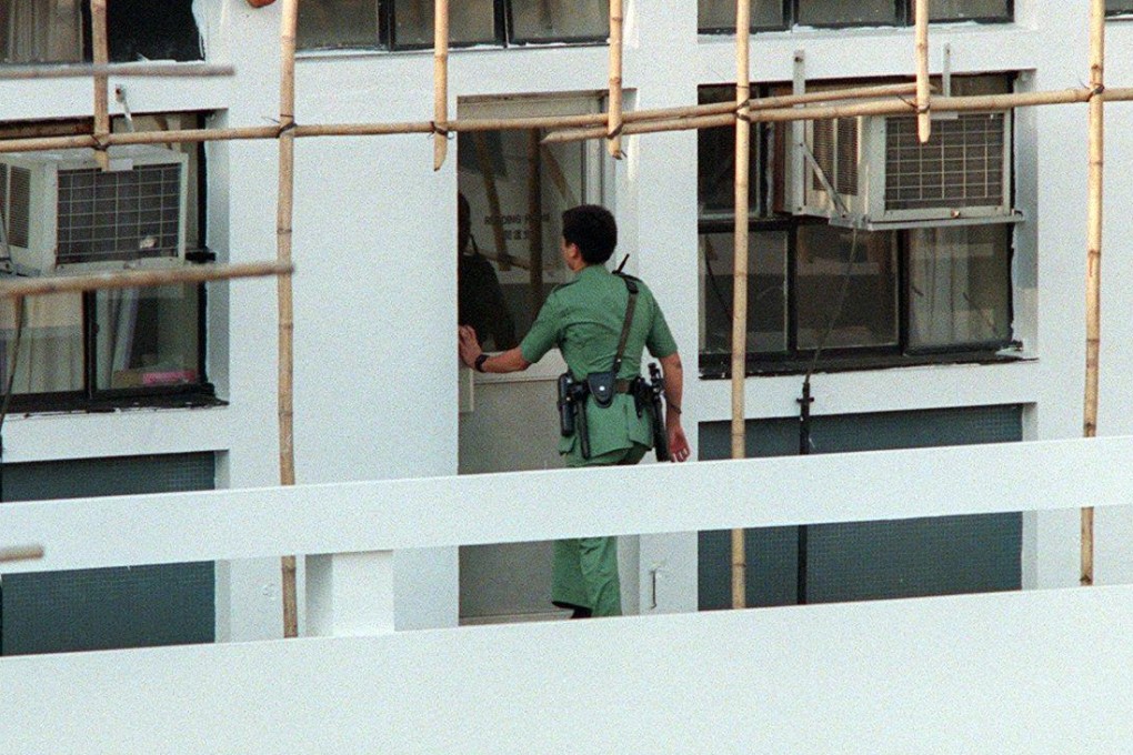 A Hong Kong policeman enters the interview room at Aberdeen police station where a young man, Chan Kwok-keung, was killed by a police constable in this photo from 1997. Photo: SCMP