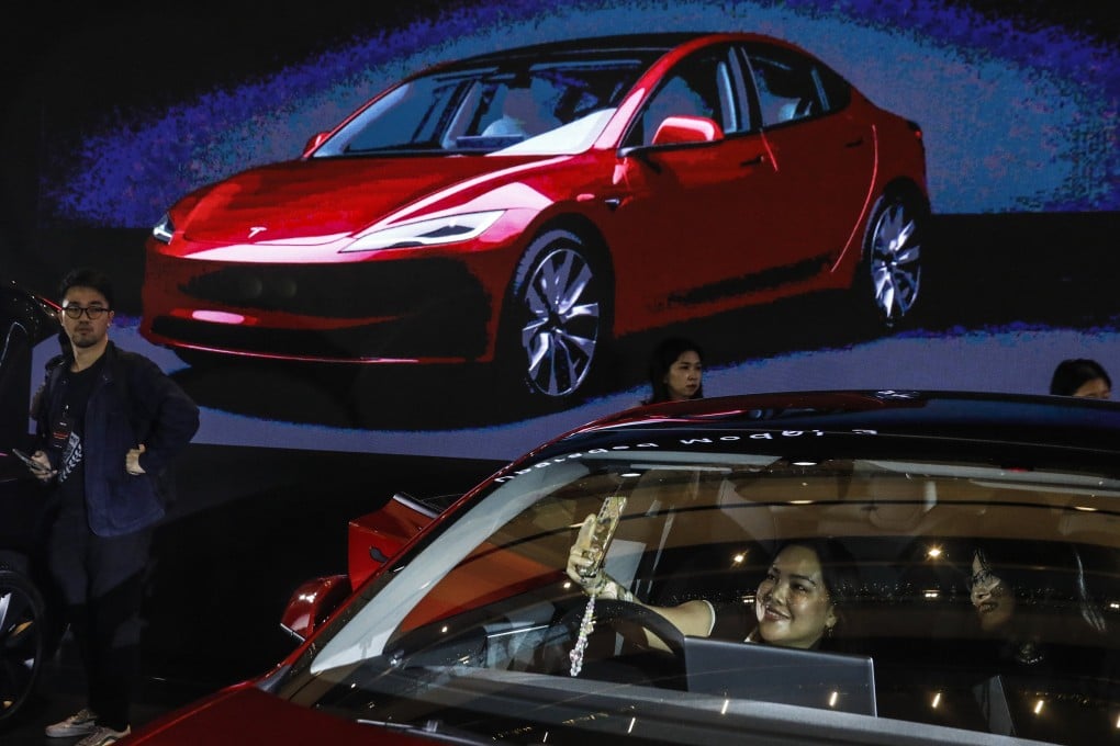 People inspect Tesla’s new Model 3 electric car during an official launch event in Malaysia last month. Photo: EPA-EFE