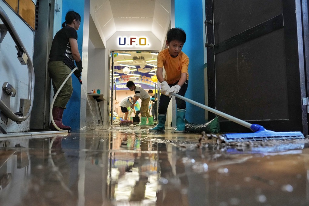 Pupils, teachers, parents and alumni of Salesian School in Shau Kei Wan, together with volunteers from the Correctional Services Department, help to clean up the campus on September 11, after Hong Kong is deluged by historic rainfall and heavy flooding. Photo: Elson Li