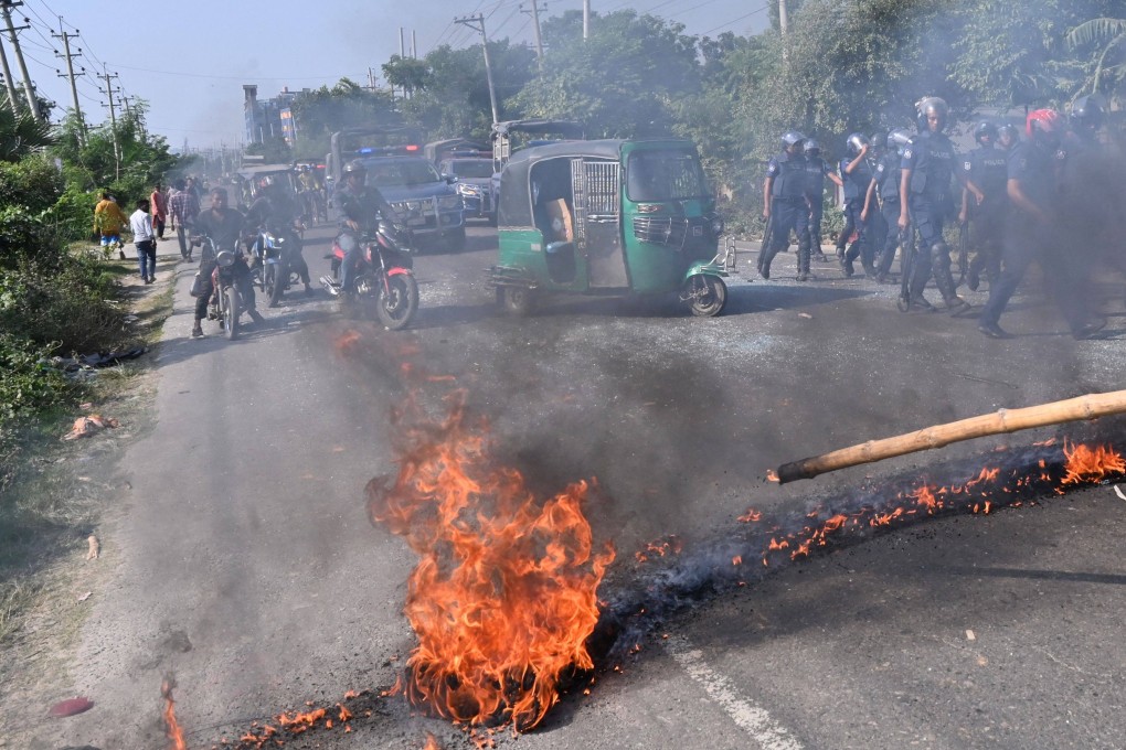 Motorists watch as Bangladesh Nationalist Party (BNP) activists set fire on a road during clashes with the police in Araihazar, some 40km from Dhaka, on Tuesday. Photo: AFP