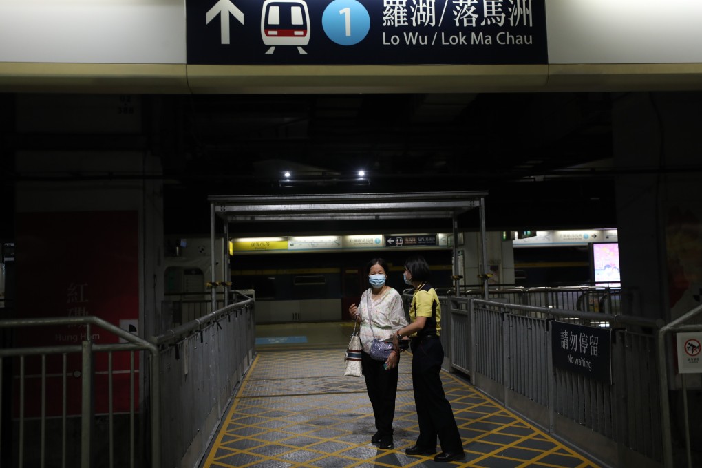 An MTR staff member speaks to a commuter surprised at a service suspension at Hung Hom station in September 2021. East Rail line services were disrupted after a man fell onto the tracks at Mong Kong East station. Photo: Xiaomei Chen