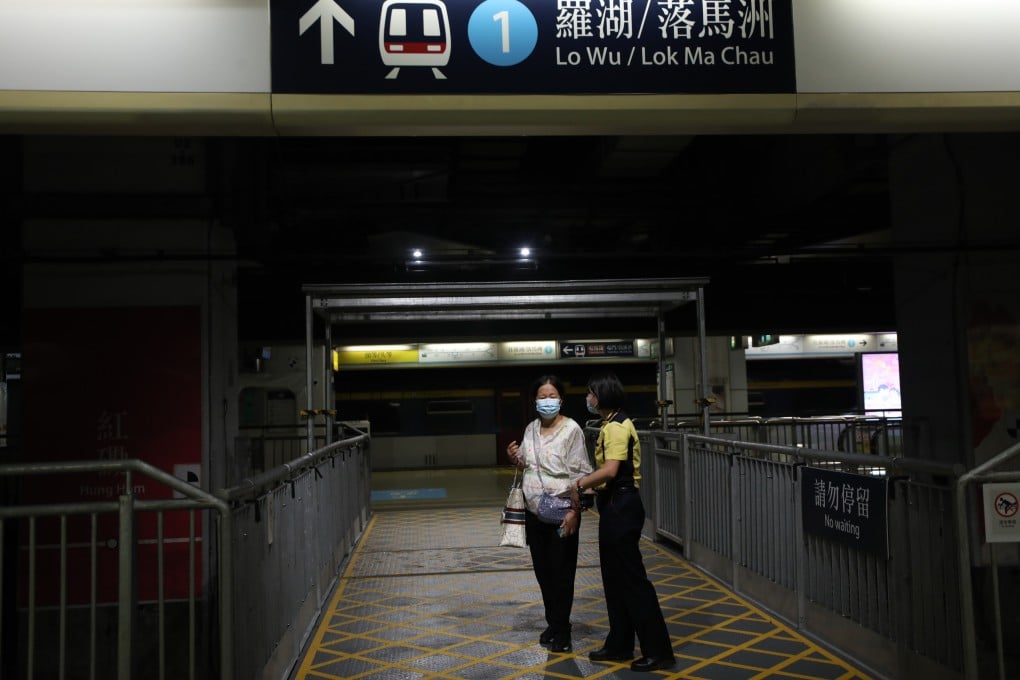 An MTR staff member speaks to a commuter surprised at a service suspension at Hung Hom station in September 2021. East Rail line services were disrupted after a man fell onto the tracks at Mong Kong East station. Photo: Xiaomei Chen