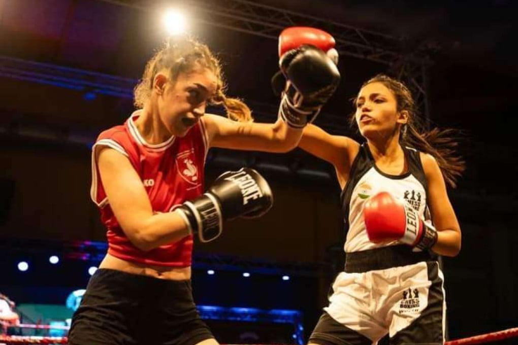 Kenza Megzari (left) blocks a punch from India’s Sneha Waykar during their match at the World Chessboxing Championships in Italy. Photo: Handout