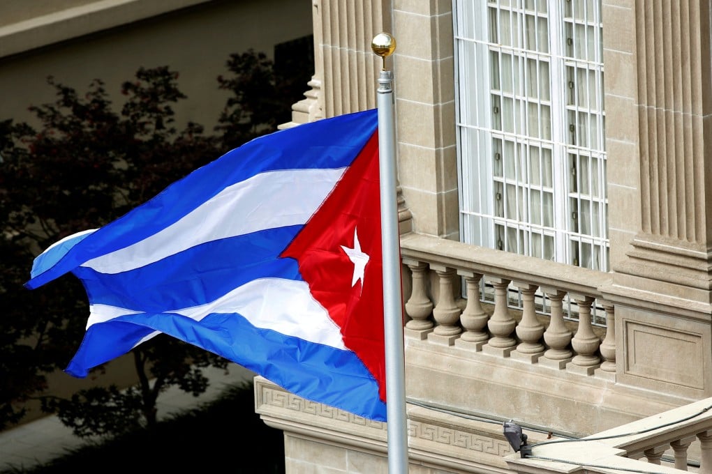 The Cuban flag flutters in the wind after being raised at the Cuban Embassy reopening ceremony in Washington July 20, 2015. Photo: Reuters