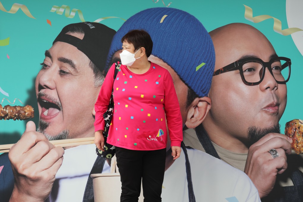 A woman waits at a tram stop, in front of an advertisement hoarding, in North Point on November 5. The government will release its GDP projections on Friday.
Photo: Xiaomei Chen