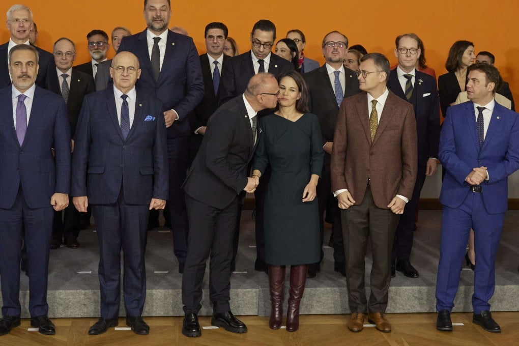 German Foreign Minister Annalena Baerbock receives a kiss from Foreign Minister Croatia Gordan Grlic Radman as they take part in a group photo with others during the European Conference on EU Enlargement, EU Reforms and the EU’s Global Capacity to Act at the German Foreign Office in Berlin on Thursday. Photo: dpa