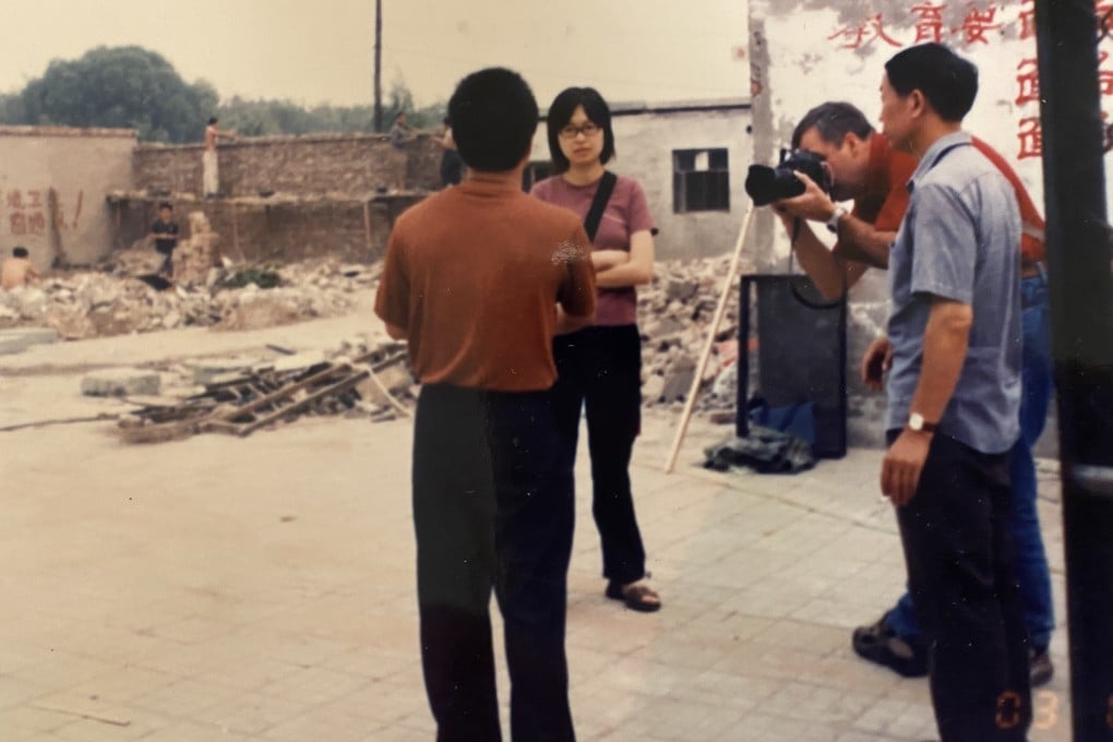 South China Morning Post journalist Josephine Ma interviews victims of demolition in Beijing in 2003, with SCMP photographer Mark Ralston.