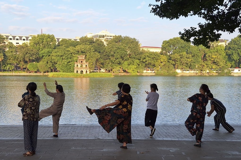 People practise tai chi beside Hoan Kiem lake in Hanoi. The Vietnamese capital is the perfect place for a short getaway from Hong Kong. We look at what there is to do. Photo: Ed Peters