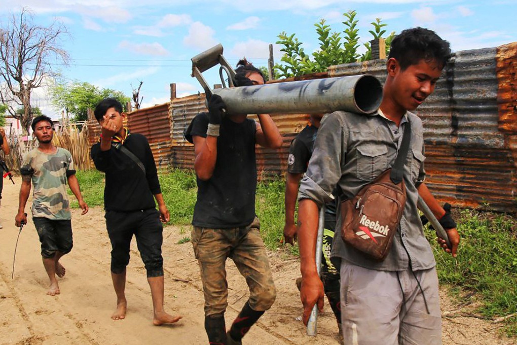 Anti-coup fighters walking with weapons in a township in Myanmar’s northwestern Sagaing region in August last year. A resident interviewed by phone said resistance fighters had taken control of the whole of Kawlin town in Sagaing as of Monday. Photo: AFP
