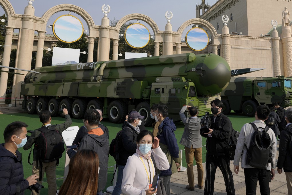 Visitors walk past military vehicles carrying the Dong Feng 41 and DF-17 ballistic missiles at a Beijing exhibition highlighting the achievements of President Xi Jinping in October 2022. Photo: AP