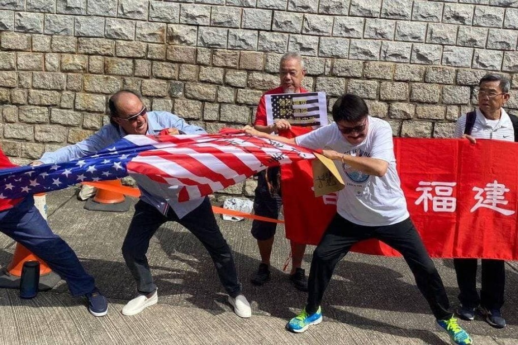 Protesters rip up an American flag outside the US consulate in Hong Kong, days after lawmakers proposed sanctions against city officials. Photo: Handout