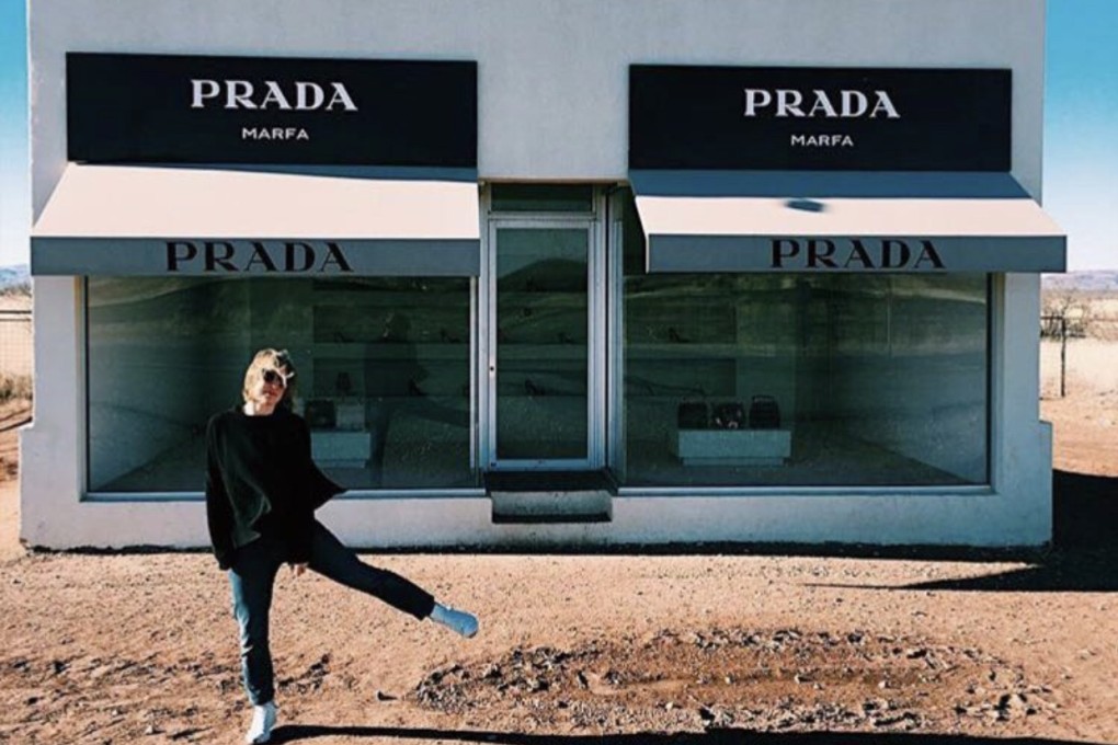Kate Jones, founder of creative agency At Liberty and eco-friendly online gift retailer Get.Give, poses outside “Prada Marfa”, a permanent sculptural art installation in the town of Marfa, in the US state of Texas. Photo: Kate Jones