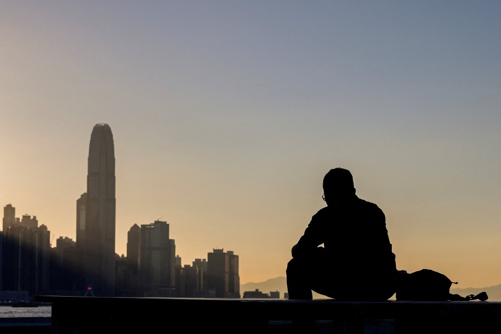 A man sits by the waterfront in Hong Kong. Photo: Reuters