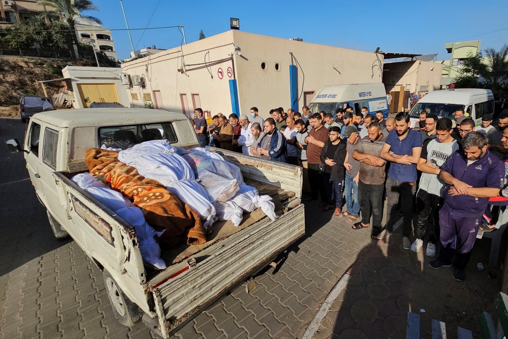 Mourners pray next to the bodies of Palestinians from a family who were killed by Israel strikes at a hospital in the northern Gaza Strip on Wednesday. Photo: Reuters