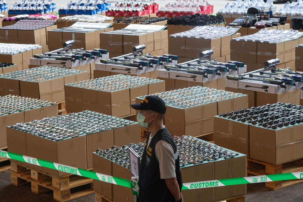 Customs officials show off some of the HK$67 million in counterfeit designer goods seized in a massive crackdown over the past few weeks. Photo: Sam Tsang