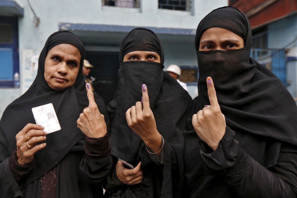 Muslim women display their inked fingers after casting their votes during the third phase of West Bengal Assembly elections in Kolkata. Photo: Reuters