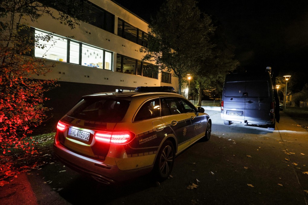 A police car is stopped in front of a school in Offenburg, Germany on Thursday after a teen gunman shot another student. Photo: EPA-EFE