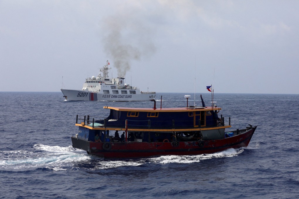 A Philippine boat sails near a Chinese coastguard ship during a resupply mission in the South China Sea on October 4. Photo: Reuters