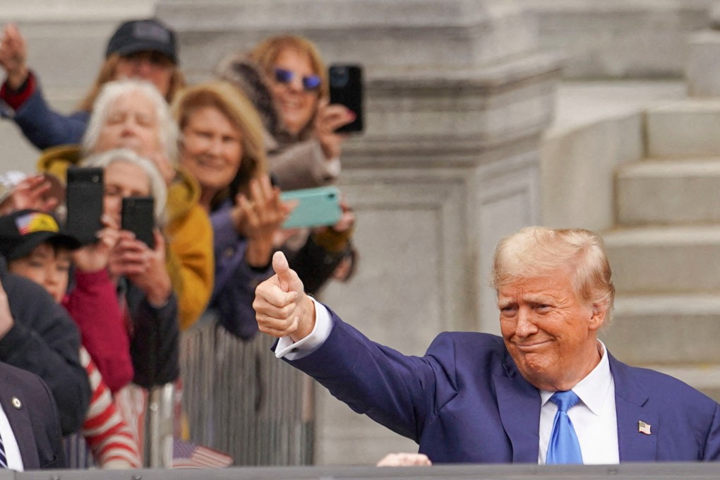 Republican presidential candidate Donald Trump gives a thumbs-up to supporters after filing the paperwork to put his name on the ballot for the primary election in Concord, New Hampshire, on October 23. Photo: Reuters