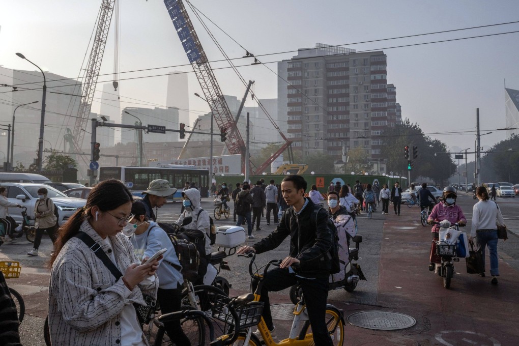 Morning commuters pass a construction site in Beijing. Major cities across China could see big changes to their urban-village areas under the nation’s new real estate development model. Photo: Bloomberg