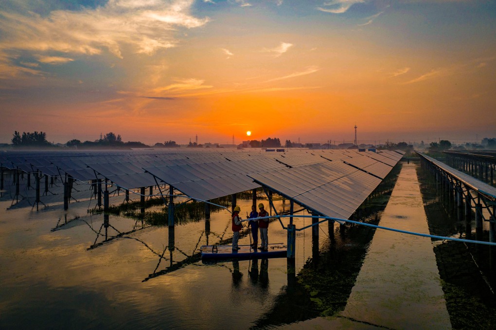 Workers inspect solar panels in the early morning at a photovoltaic power generation base in Taizhou, in China’s Jiangsu province, on July 12. Carbon emission reduction is the only long-term solution to climate change and must remain our top priority. Photo: AFP