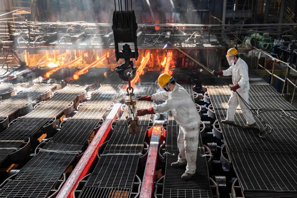 Workers make iron bars in a steel factory in Lianyungang, in Jiangsu province, on February 12, 2021. China’s exposure to the Carbon Border Adjustment Mechanism is mostly concentrated in the steel sector, which represents less than 2 per cent of the value of Chinese exports to the EU. Photo: AFP