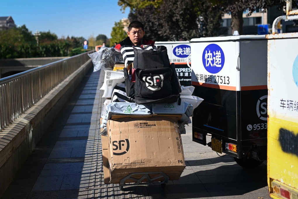 A delivery man pushes a trolley of packages outside a shopping centre in Beijing on November 11. The government has made increased domestic consumption a key part of its plan to grow the economy, but the property sector crisis and a reluctance on Beijing’s part to cede control have kept China’s animal spirits largely caged. Photo: AFP