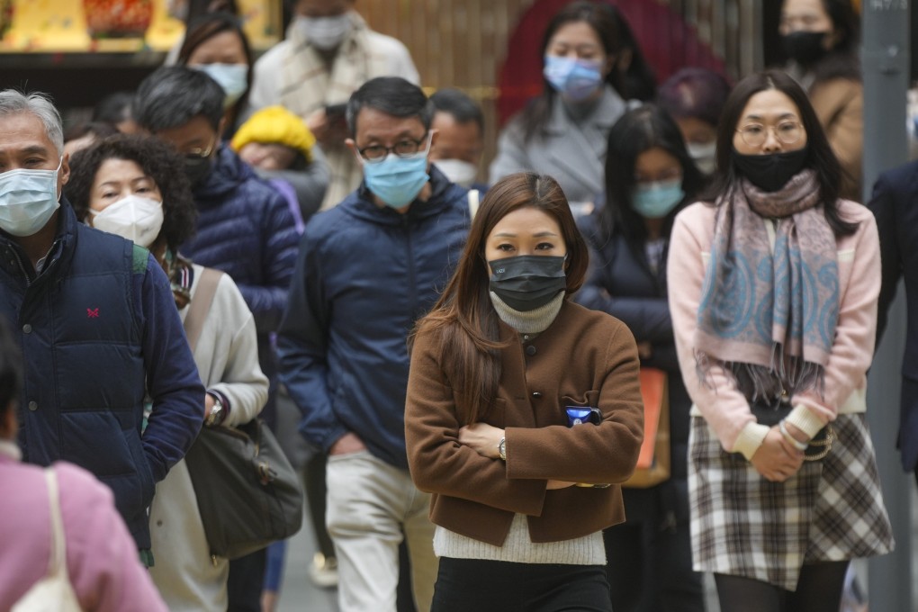 People wear warm clothes on a cold day in Hong Kong. The weather forecaster says it will be mainly cloudy and dry on Tuesday. Photo: Sam Tsang