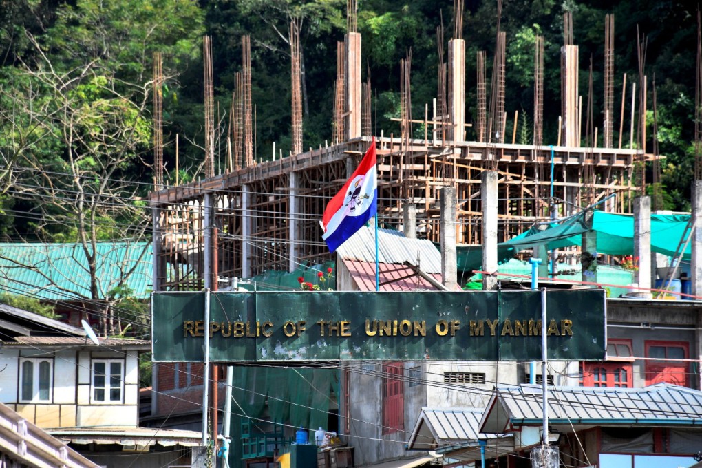 A flag of one of the Myanmar rebel forces is installed next to an under-construction structure in Myanmar’s Khawmawi village on the India-Myanmar border as seen from Zokhawthar village in Champhai district of India’s northeastern state of Mizoram, India, on Tuesday. Photo: Reuters