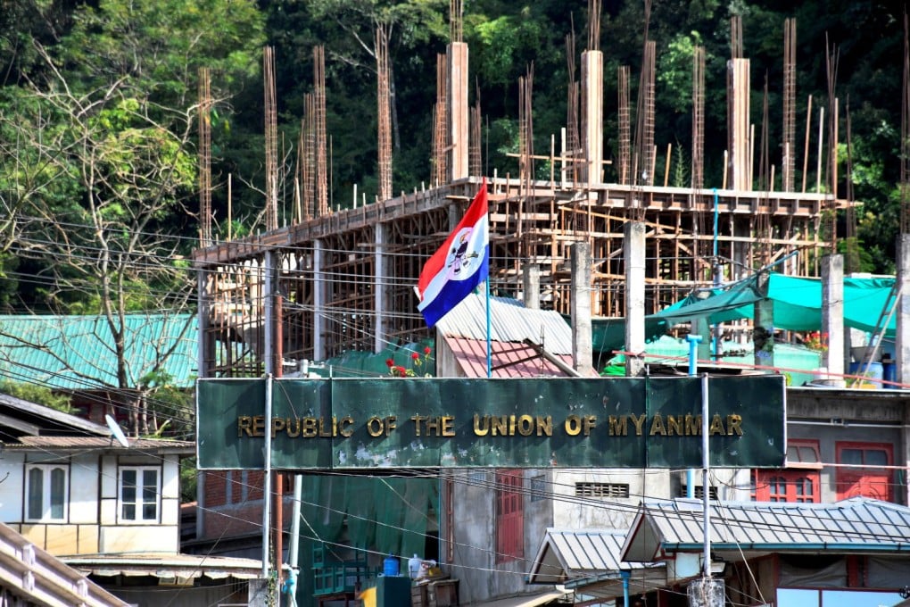 A flag of one of the Myanmar rebel forces is installed next to an under-construction structure in Myanmar’s Khawmawi village on the India-Myanmar border as seen from Zokhawthar village in Champhai district of India’s northeastern state of Mizoram, India, on Tuesday. Photo: Reuters