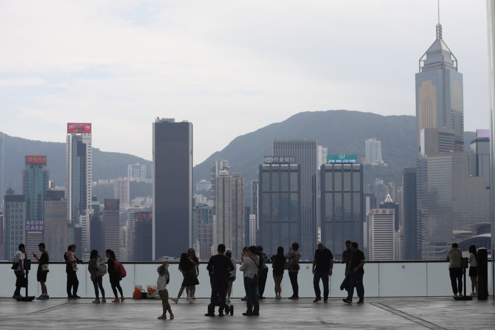 Tourists enjoy the view of the Hong Kong skyline in Tsim Sha Tsui. Photo: Xiaomei Chen