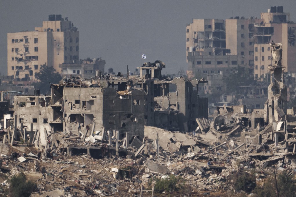 An Israeli flag stands on the top of a destroyed building in the Gaza Strip on November 15. Photo: AP